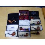 A COLLECTION OF PETERSON OF DUBLIN PIPES AND WOODEN DISPLAY STANDS, including several pipe of the