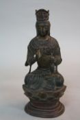 AN ORIENTAL BRONZE FIGURE OF A SEATED BUDDHA, traces of gilding and pink/red pigment, posed with