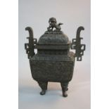 AN ORIENTAL BRONZE KORO, of rectangular form, dog of fo finial above domed cover, cast with