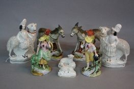 A PAIR OF VICTORIAN STAFFORDSHIRE POTTERY FIGURES OF RECUMBENT SHEEP, frit decoration, heights