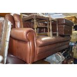 A BROWN LEATHER TWO PIECE LOUNGE SUITE, comprising of a three seater settee and an armchair