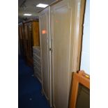 A BLEACHED WALNUT THREE PIECE BEDROOM SUITE, comprising of a two door wardrobe, chest of five long