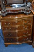 A MODERN MAHOGANY SERPENTINE CHEST, of four long graduated drawers below a brushing slide,