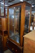 A SINGLE DOOR CHINA CABINET, and a walnut chest of four drawers (2)