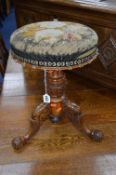 A VICTORIAN SWIVEL TOP PIANO STOOL, with needlework top (sd)