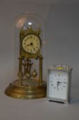 A BRASS DOMED ANNIVERSARY CLOCK, No.32854 to back , together with a small clock (2)