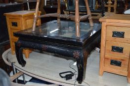 AN ORIENTAL STYLE SQUARE COFFEE TABLE, with carved detail and glass insert top, approximate size