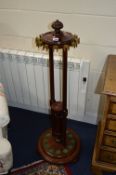 A VICTORIAN WALNUT AND MAHOGANY CIRCULAR REVOLVING SNOOKER CUE STAND, fitted to hold twelve cues