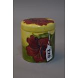 A MOORCROFT POTTERY COVERED POT, 'Hibiscus'pattern on green/yellow ground, impressed mark to base,