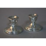 A PAIR OF STERLING SILVER WEIGHTED DWARF CANDLESTICKS (2)