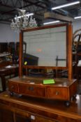 A WALNUT SWING MIRROR WITH THREE DRAWERS (s.d.)