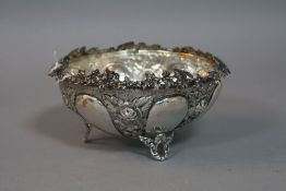 A GREEK SILVER EMBOSSED DISH, with vine leaf decoration to the top, impressed 'EPT XEIPOE',