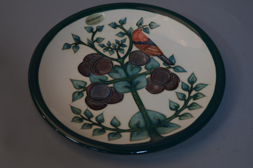 A MOORCROFT POTTERY PLATE, plum tree and bird pattern, impressed marks to base, approximate diameter