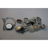 A SILVER CHARM BRACELET, with various charms, fobs, etc, together with a S W R ladies watch
