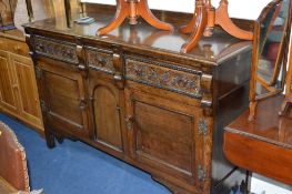 A CARVED OAK SIDEBOARD, with one short and two long drawers, approximate size width 154cm x depth