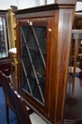 AN EDWARDIAN MAHOGANY AND INLAID HANGING CORNER CUPBOARD, (sd, losses) (no key)