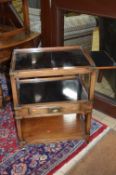 A HARDWOOD CAMPAIGN STYLE THREE TIER TROLLEY, with double drawing slides to sides, gallery top and