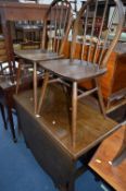 AN OAK GATELEG TABLE, and four hoop back Ercol chairs (5)