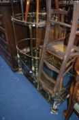 A BRASSED COFFEE TABLE, with glass top and a similar tea trolley (2)