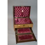 A BURR WALNUT TRAVELLING BOX, with padded interior and pull-out fitted writing slope and letter rack