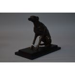 A BRONZED FIGURE OF A SEATED GREYHOUND (?), on black stepped wooden plinth, approximate height 17.