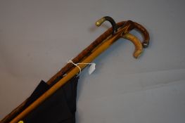 THREE WALKING STICKS, one silver tipped and an umbrella (4)