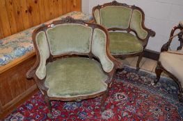 A PAIR OF FRENCH VICTORIAN MAHOGANY GREEN UPHOLSTERED ARMCHAIRS, with foliate carving to the top and