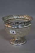 AN EDWARDIAN SILVER AND CUT GLASS BOWL, silver rim embossed with floral swags, fluted circular foot,