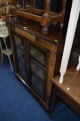 A VICTORIAN WALNUT AND INLAID TWO DOOR GLAZED PIER CABINET, with metal gilding, approximate size