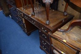 A MAHOGANY PEDESTAL DESK, with nine drawers and brown tooled leather inlay top (sd) (key)