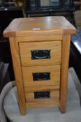 A PAIR OF LIGHT OAK THREE DRAWER BEDSIDE CHESTS