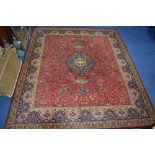 A 100% WOOL CARPET SQUARE, red, gold and blue ground, Woodward Grosvenor Persian Reproductions label