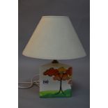 A SMALL TRIANGULAR LAMP BASE, in the style of clarice cliff, painted with Autumn Trees, with a