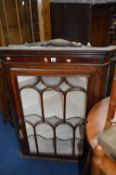 A GEORGIAN OAK ASTRAGAL GLAZED HANGING CORNER CUPBOARD, with painted interior (sd)
