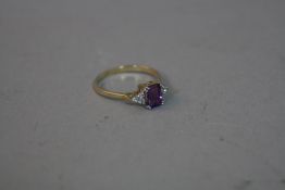 A 9CT RING SET WITH AN AMETHYST AND SIX DIAMONDS, approximate weight 2.1 grams