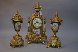 A FRANZ HERMLE FRENCH STYLE GILT METAL AND PORCELAIN CLOCK GARNITURE (some damage to porcelain and