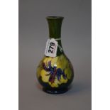 A MOORCROFT POTTERY BUD VASE, Hibiscus pattern on green ground, paper label to base, approximate