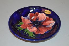 A MOORCROFT POTTERY DISH, Clematis pattern, impressed and painted backstamp and signature to base,