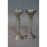 A PAIR OF ELIZABETH II SILVER POSY VASES, wavy rims, square tapering stems, loaded circular bases,