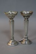 A PAIR OF ELIZABETH II SILVER POSY VASES, wavy rims, square tapering stems, loaded circular bases,