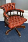 A MAHOGANY OX BLOOD BUTTONED SWIVEL OFFICE/STUDY CHAIR, (sd)