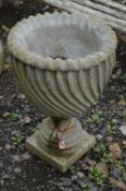 A COMPOSITE FLUTED GARDEN URN, constructed in one piece, diameter 47cm at top x height 68cm