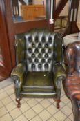 A GREEN LEATHER BUTTONED WING BACK ARMCHAIR, approximate size inner arm width 45cm x height 108cm
