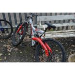 A SHOCKWAVE DIRT 4 MOUNTAIN BIKE, with swing arm rear suspension and front suspension, front and