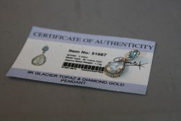 A 9K GLACIER TOPAZ AND DIAMOND GOLD PENDANT, (certificate)