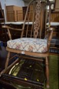 AN OAK WHEELBACK ROCKING CHAIR, an oak sewing box and a brass topped folding occasional table (3)