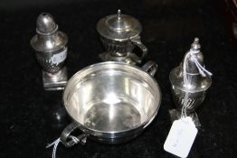 A SILVER TWIN HANDLED DISH, and a silver three piece condiment set