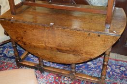 A GEORGIAN OAK OVAL TOPPED GATE LEG TABLE, with two drawers, approximate size width 160cm x depth