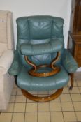 A STRESSLESS GREEN LEATHER RECLINING ARMCHAIR, and footstool (sd) (2)