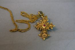 AN 18CT CROSS, approximate weight 3.9 grams on a yellow metal chain, approximate weight 2.2 grams